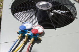 AC replacement in progress with HVAC manifold gauge set attached to outdoor condenser unit.
